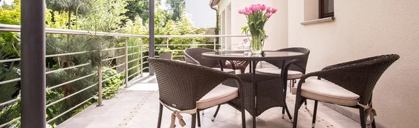 Round table and wicker armchairs