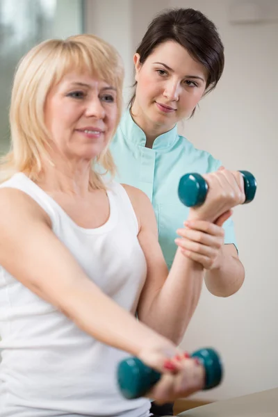 Woman Exercises with dumbbells