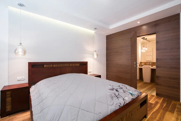 Double bed in wooden bedroom