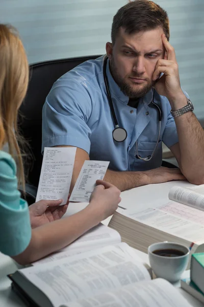 Doctors studying books