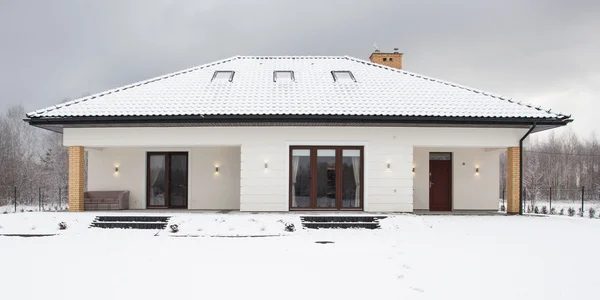 Snow-covered detached house