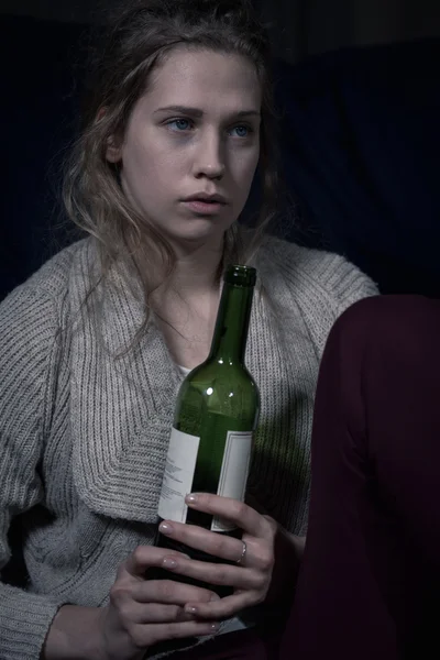 Young lonely woman with wine