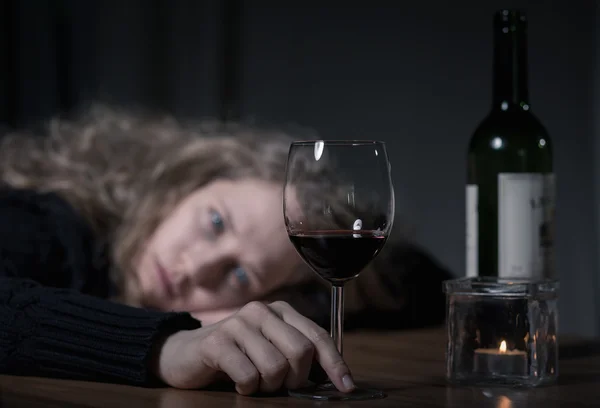Depressed woman with wine