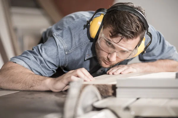 Carpenter at work with wood