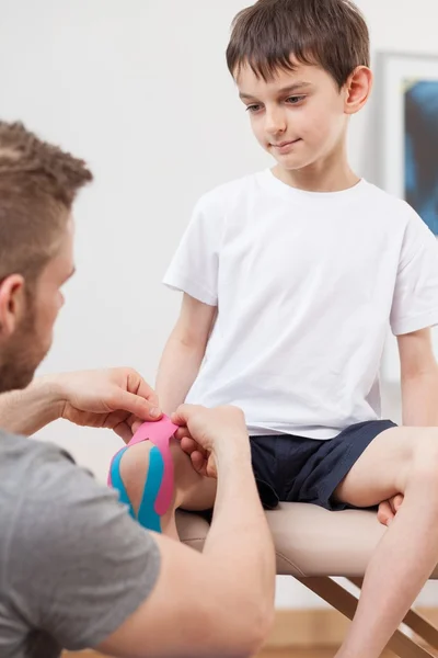 Small boy during kinesiology therapy