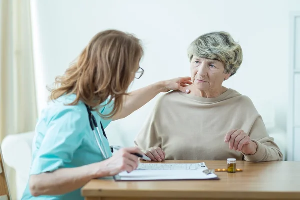 Doctor diagnosing elder woman