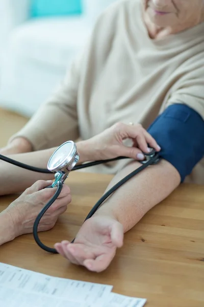 Woman having measured blood pressure