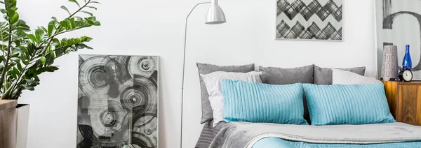 Grey and turquoise decorations in bedroom