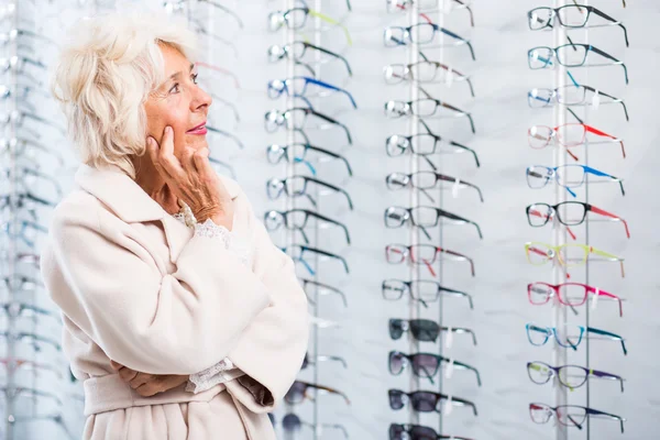 Senior lady chosing eyeglass frames