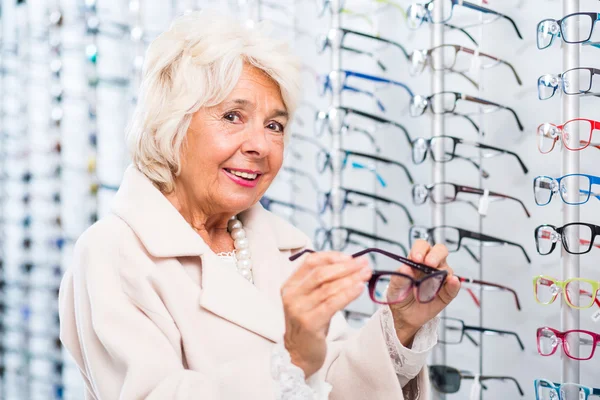 Opticians female patient buying glasses