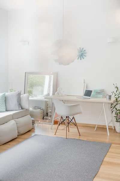 White room with simple furniture