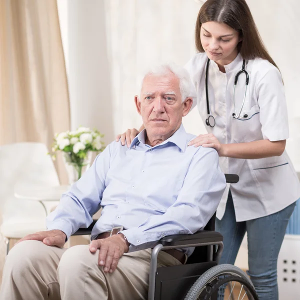 Nurse with old man on wheelchair