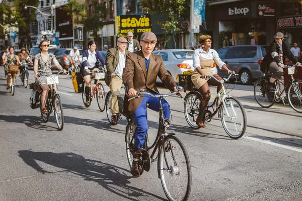 Toronto, Canada - September 20, 2014: Unidentified participants of Tweed Ride Toronto in vintage style clothes riding on their bicycles. This event is dedicated to the style of old England