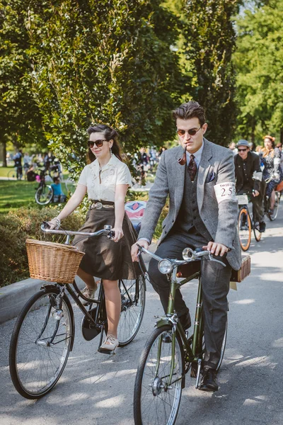 Toronto, Canada - September 20, 2014: Unidentified participants of Tweed Ride Toronto in vintage style clothes riding on their bicycles. This event is dedicated to the style of old England.