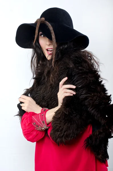 Beautiful girl in hat and with fur