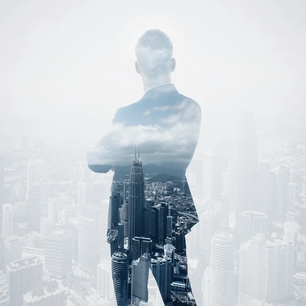 Photo of stylish adult businessman wearing trendy suit and looking city. Double exposure, panoramic view contemporary City background. Square