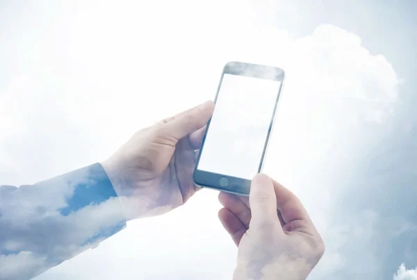 Double exposure photo businessman holding modern smartphone hands. Reflection of clouds background, white blank screen ready for your business information. Horizontal mockup.