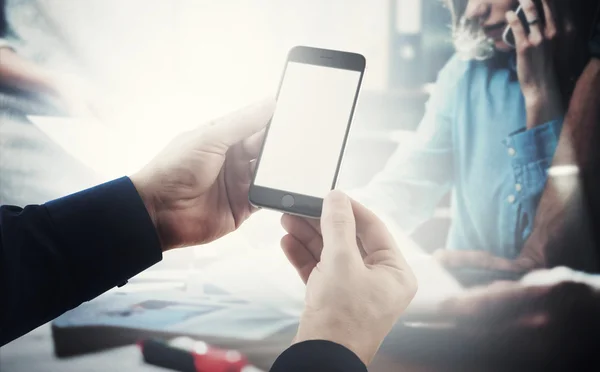 Photo businessman holding modern smartphone hands.Business team meeting process background. Isolated blank screen ready for your business information. Horizontal mockup.