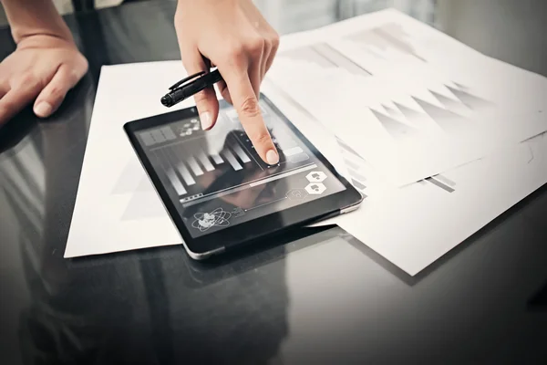Photo woman working market reports modern tablet and touching screen with worldwide stock exchange icons. Documents for sign on the table. Horizontal. Film effect