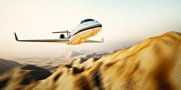 Photo of white modern and luxury generic design private jet flying in blue sky at sunrise.Uninhabited desert mountains background.Business travel picture.Horizontal,motion blurred effect.3d rendering