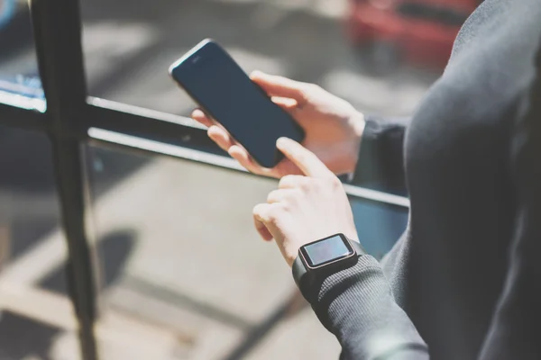 Picture Woman Working Modern Studio,Wearing Generic Design Smart Watch Hand.Female Finger Touching Screen Mobile Phone.Manage Work Process. Horizontal. Burred background. Film effects