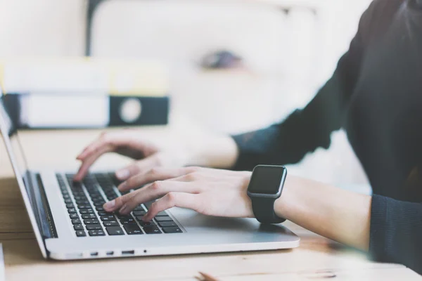 Work Process in Modern Office.Finance Account Manager Working at Wood Table with New Business Project.Typing Contemporary Laptop keyboard,Wearing Smart Watch. Horizontal mockup. Film effect. Blurred