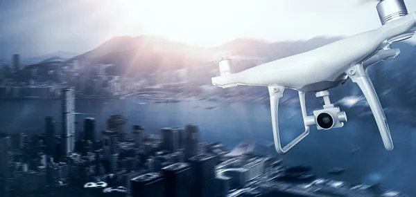 Photo White Matte Generic Design Remote Control Air Drone with action camera Flying Sky under City. Modern Megapolis Sunset Background. Wide, front side view. Motion Blur Effect. 3D rendering.