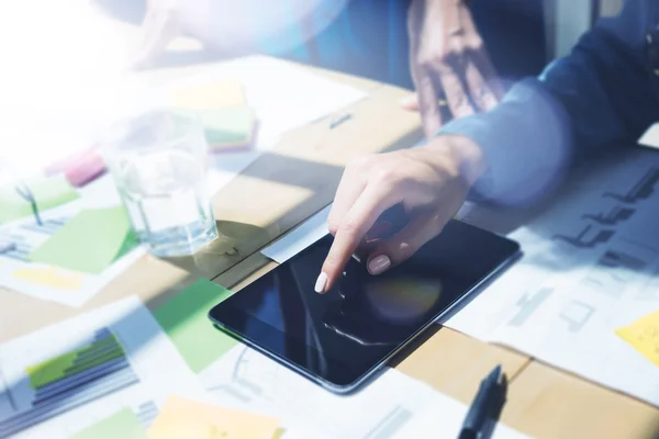 Woman Touch Display Digital Tablet Hand.Project Managers Researching Process.Business Team Working Startup modern Office.Analyze market stock.Use electronic devices,papers,notes wood table.Blurred.