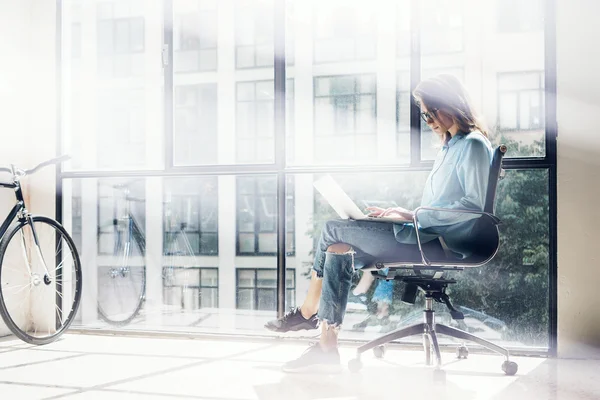 Hipster Girl using Laptop huge Loft Studio.Student Researching Process Work.Young Business Woman Working Creative Startup modern Office.Analyze new marketing strategy.Blurred,film effect.Horizontal.