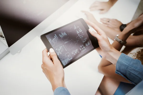 Woman Touching Screen Electronic Tablet Hand.Project Managers Researching Process.Business Team Working New Startup modern Office.HiTech Virtual Digital Charts Interfaces.Analyze market stock.Blurred.