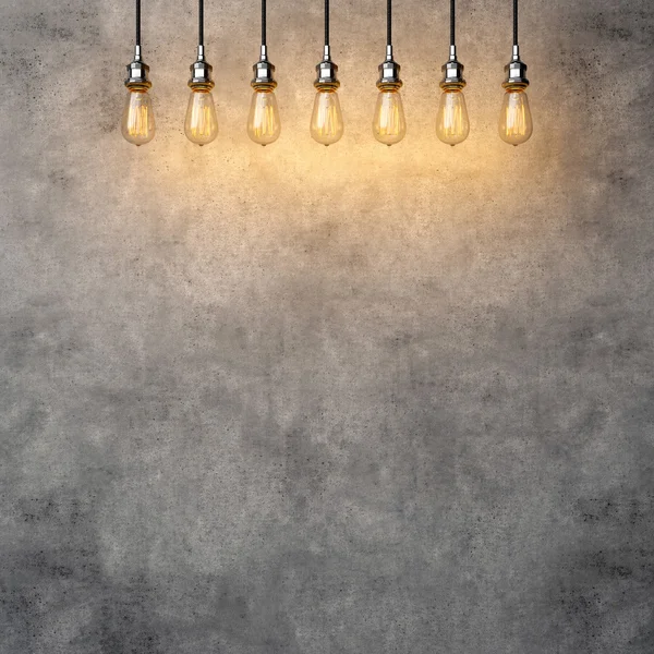 Decorative vintage lightbulbs with concrete background