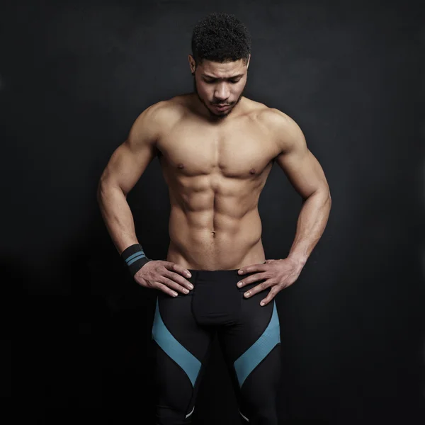 Athletic  man on black wall background