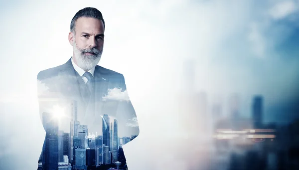 Portrait of bearded businessman in suit and double exposure city on the background. Horizontal