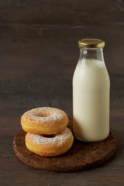 Powdered sugar donuts and milk