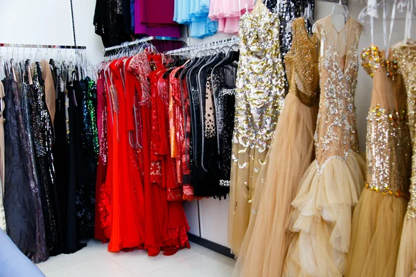 Evening dresses on hangers in store