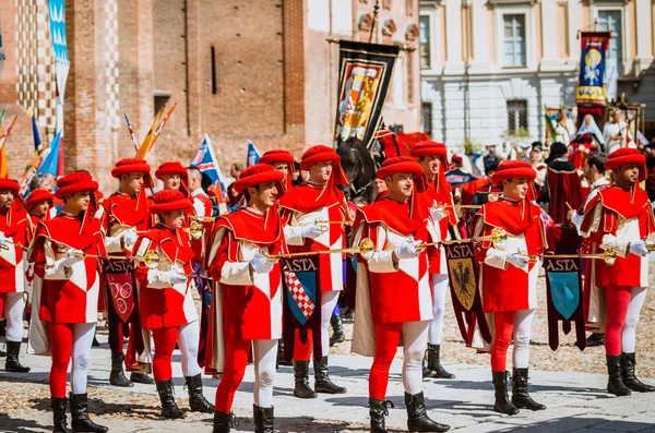 Flag-wavers of the districts and trumpeter in medieval parade