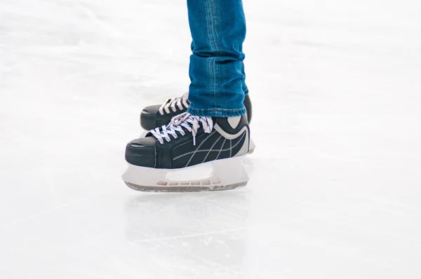 Legs of skater on winter ice rink