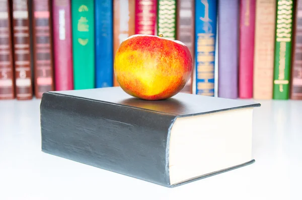 Books with apple on white background