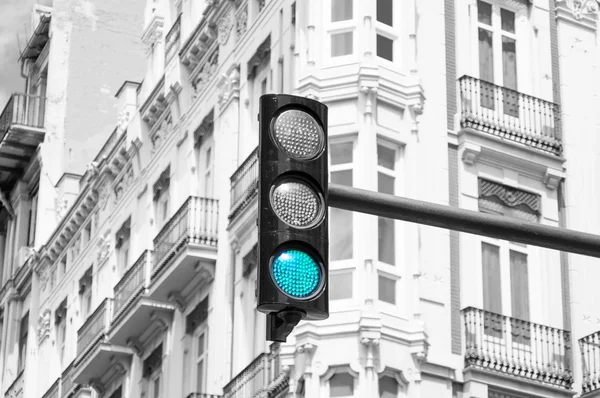 Green traffic light in the city. Black and white photo.