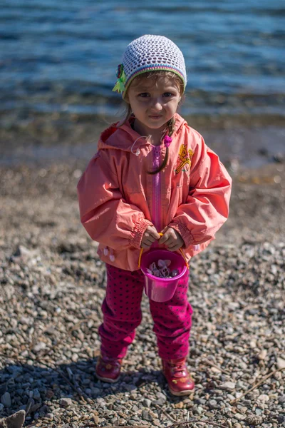 Baby on a sandy beach.