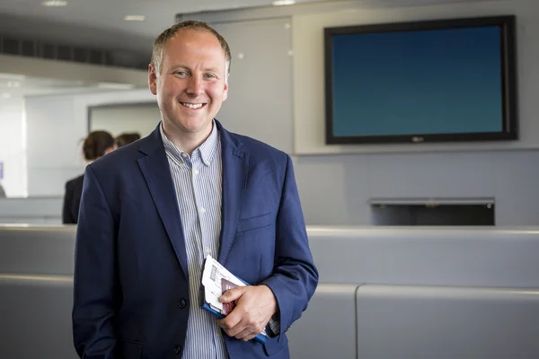 Businessman with passport and boarding pass at the airport