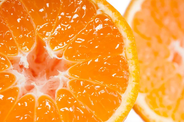 Vibrant juicy orange tangerine fruit half whithout pits macro close up