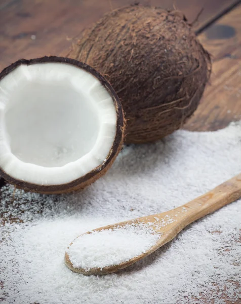 Close up of a coconut and grounded coconut flakes