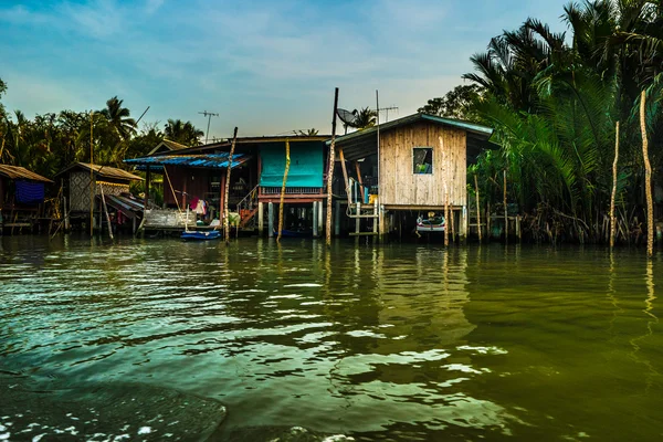 Stilt houses above river in rural Thailand.