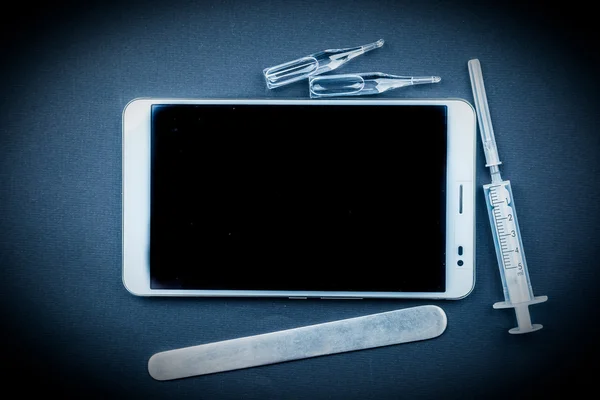 Tablet pc with medical objects on a desk