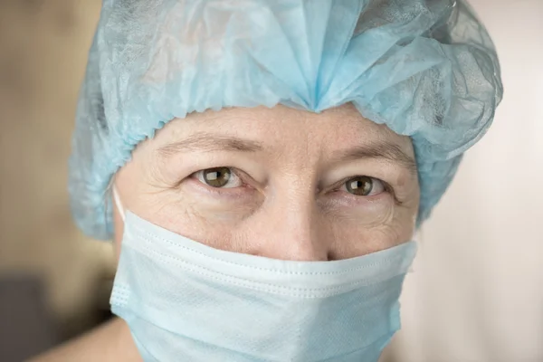 Smiling female doctor in hospital hallway