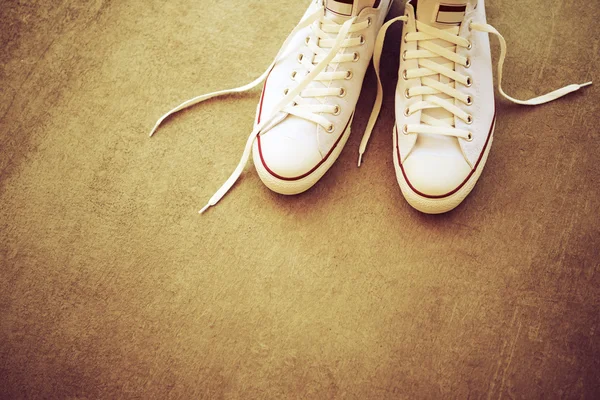 White sneaker on road background, top view.