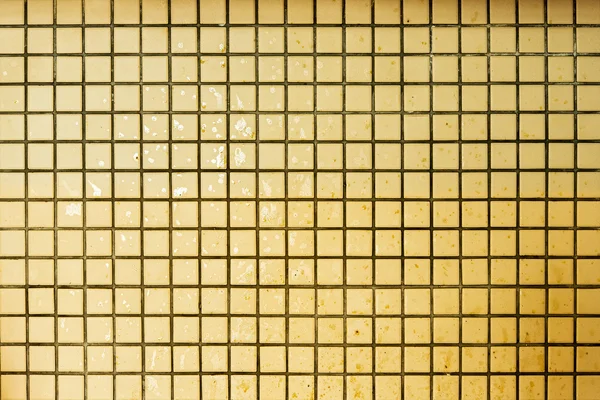 Old grunge mosaic wall. Yellow wall backgrounds.