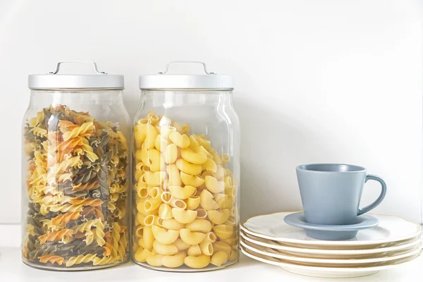 Pasta in a jar and coffee cup in kitchen