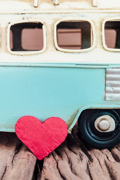 Red heart with part of vintage blue van background on old wooden